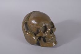 A BRONZE SKULL with headphones.