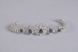 A SUPERB 18CT WHITE GOLD SAPPHIRE AND DIAMOND BRACELET set with four sapphires and 160 diamonds.