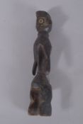 AN EARLY TRIBAL CARVED WOOD FIGURE. 14ins high.