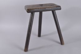 AN EARLY OAK CUTLERS STOOL. 18ins high.