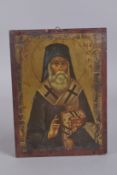 A GOOD RUSSIAN ICON, a priest, on wood. 10ins x 7.5ins.
