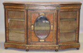 A GOOD VICTORIAN BURR WALNUT AND ORMOLU CREDENZA, the central panelled door having an oval mirror