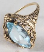 A 9CT GOLD AND BLUE TOPAZ RING.