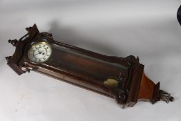 AN AUSTIN MAHOGANY WALL CLOCK. 2ft 6ins long.