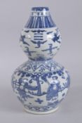 A CHINESE BLUE AND WHITE PORCELAIN DOUBLE GOURD VASE, with cranes and figures. 37cms high.