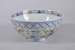 A CHINESE WUCAI BLUE AND WHITE PORCELAIN BOWL, painted with dragons. 20cms diameter.