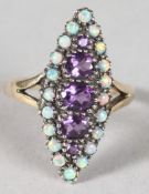 A 9CT GOLD, AMETHYST AND OPAL MARQUISE SET RING.