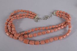 A THREE ROW CORAL AND PEARL NECKLACE.