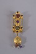 A NATASHA GILT METAL AND CABOUCHON STONE BROOCH