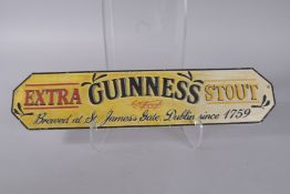 A CAST IRON GUINNESS SIGN. 22ins high.
