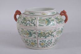 A CHINESE FAMILLE VERTE PORCELAIN TWIN-HANDLE JAR, with panels of phoenix and dragons. 18.5cms