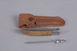 A LE COMMARGUAIS FOLDING KNIFE in a leather case.