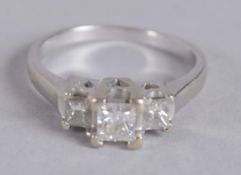 A 14CT GOLD THREE STONE DIAMOND RING.