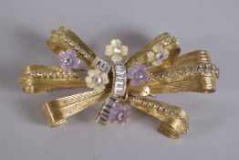 DOLCE AND GABBANA, MADE IN ITALY A GILT METAL DIAMOND AND ENAMEL FLOWER HEAD BROOCH, signed.