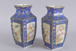 A PAIR OF CHINESE BLUE VASES with panels of birds and flowers. 10ins high.