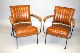 A PAIR OF LEATHER ARMCHAIRS with metal frame and wooden arms.