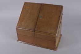 A VICTORIAN OAK STATIONERY BOX, the pair of hinged covers opening to reveal a fitted interior. 15.