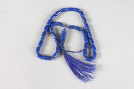A LAPIS BEAD NECKLACE with tassel. 17ins long.