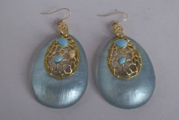 TWO ALEXIS BITTAR TEAL BLUE LUCITE STONE PENDANTS with oval name plaque.