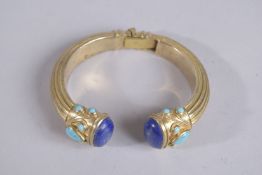 A STERLING SILCER LAPIS TURQUOISE BANGLE.