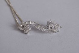 A GOOD 18CT WHITE GOLD DIAMOND PENDANT with baguette diamonds and two cluster diamonds, on a gold