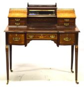 AN EDWARDIAN MAHOGANY WRITING DESK, the upper section with central mirror and shelf flanked by