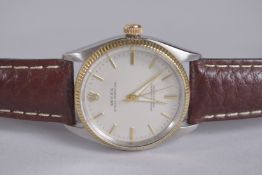 A GOOD ROLEX OYSTER PERPETUAL GOLD AND STEEL WRIST WATCH with leather strap, with box.