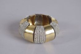 A KENNETH LANE VINTAGE GILT METAL AND DIAMONTI STRETCH BRACELET, signed, 3ins diameter.