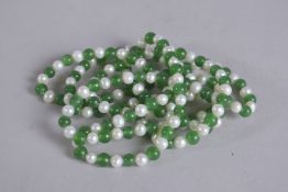 A LONG STRING OF JADE AND PEARL BEADS. 46ins long.