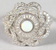 A SILVER CIRCULAR OPAL RING.