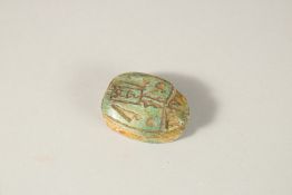 AN EGYPTIAN CARVED SCARAB BEAD, 3.5cm long.