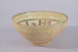 A SELJUK SGRAFFIATO POTTERY BOWL, 17.5cm diameter.