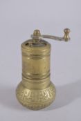 AN ISLAMIC BRASS SALT / PEPPER GRINDER, 11cm high.
