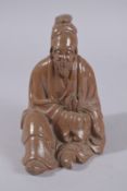 A CHINESE GLAZED POTTERY SEATED FIGURE, 22cm high.