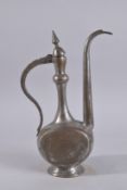 AN EARLY 20TH CENTURY QAJAR OR AFGHAN TINNED COPPER EWER, 39cm high.