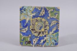 A PERSIAN QAJAR GLAZED POTTERY TILE, painted with floral motif, 20cm square.