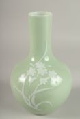 A CHINESE CELADON GLAZE PORCELAIN FLORAL BOTTLE VASE, the base with character mark, 26cm high.
