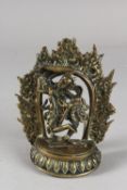 AN 18TH-19TH CENTURY TIBETAN OR NEPALESE BRONZE FIGURE OF A DEITY, with flaming halo, 15.5cm high.