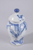 A CHINESE BLUE AND WHITE PORCELAIN JAR AND COVER, painted with figures in a garden, 13cm high.