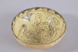 A SELJUK SGRAFFIATO POTTERY BOWL, depicting a man riding a horse, 1cm diameter.