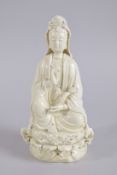 AN EARLY 20TH CENTURY DEHUA PORCELAIN GUANYIN, with two impressed seal marks to the reverse, 27cm