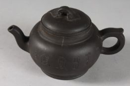 A CHINESE BLACK YIXING TEAPOT, with impressed mark to base.