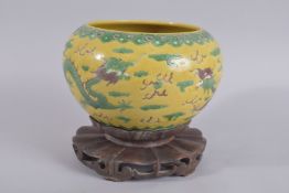 A 19TH CENTURY CHINESE SANCAI PORCELAIN DRAGON BOWL ON HARDWOOD STAND, bowl with carved character