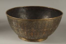 A FINELY ENGRAVED 19TH CENTURY PERSIAN QAJAR BRASS BOWL, 25cm diameter.