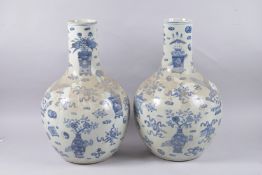 A VERY LARGE PAIR OF CHINESE BLUE AND WHITE PORCELAIN VASES, painted with vases of flowers and