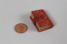 A RARE 19TH-20TH CENTURY LEATHER BOUND MINIATURE QURAN, 3.8cm x 2.5cm.