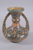 A TUNISIAN ISLAMIC TWIN HANDLE GLAZED POTTERY VASE, 22.5cm high.