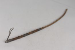 A 19TH CENTURY INDIAN WHIP, mounted with engraved silver bands, 52cm long.