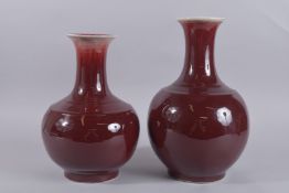 TWO LARGE CHINESE SANG DE BOEUF GLAZE VASES, largest 39cm high.