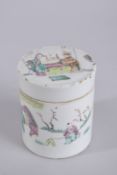 A 19TH CENTURY FAMILLE ROSE PORCELAIN CYLINDRICAL TEA CADDY, painted with figures, 12cm high.